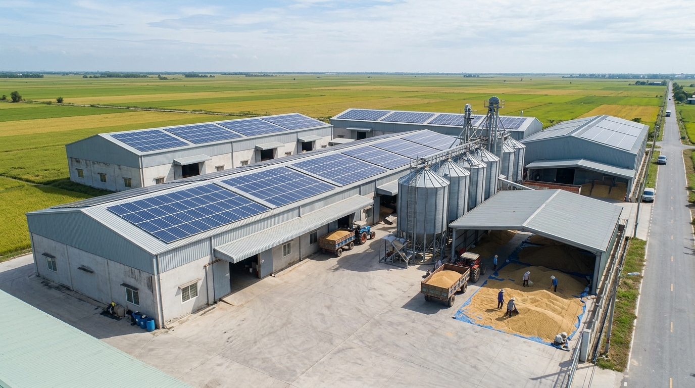 Aerial view of commercial rooftop solar plant installed on industrial rice mill shed roofs